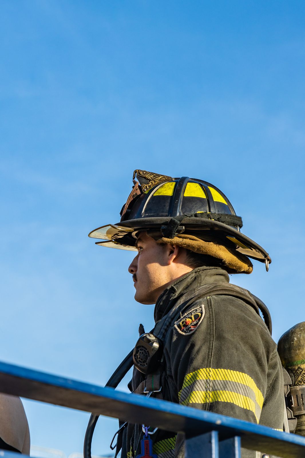 Firefighter in turnout gear looking up the stadium stairs