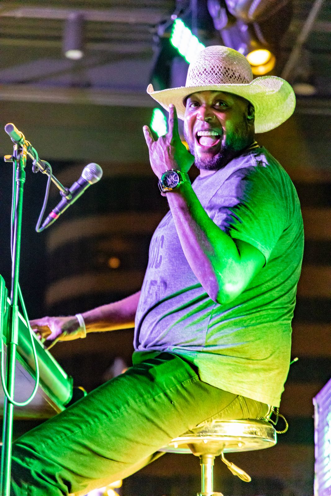 Performer smiling at the piano on stage